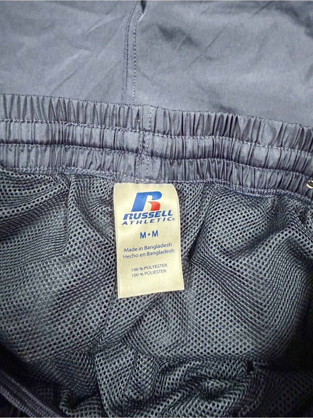 Vintage Russell Athletic navy blue track pants with blue side stripe, size M